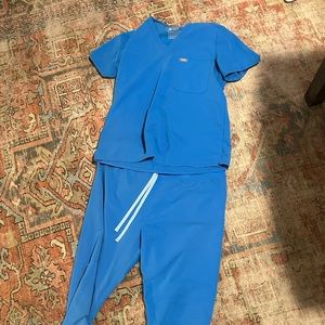 Figs scrubs. Top and bottom. Both size large. Color is Capri Blue